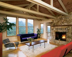 The focal point in the new living room is the original fireplace, sandblasted to brighten the discolored, dark-orange stone. The fireplace also provides a sense of history and much-needed thermal mass, absorbing and holding heat in the house.